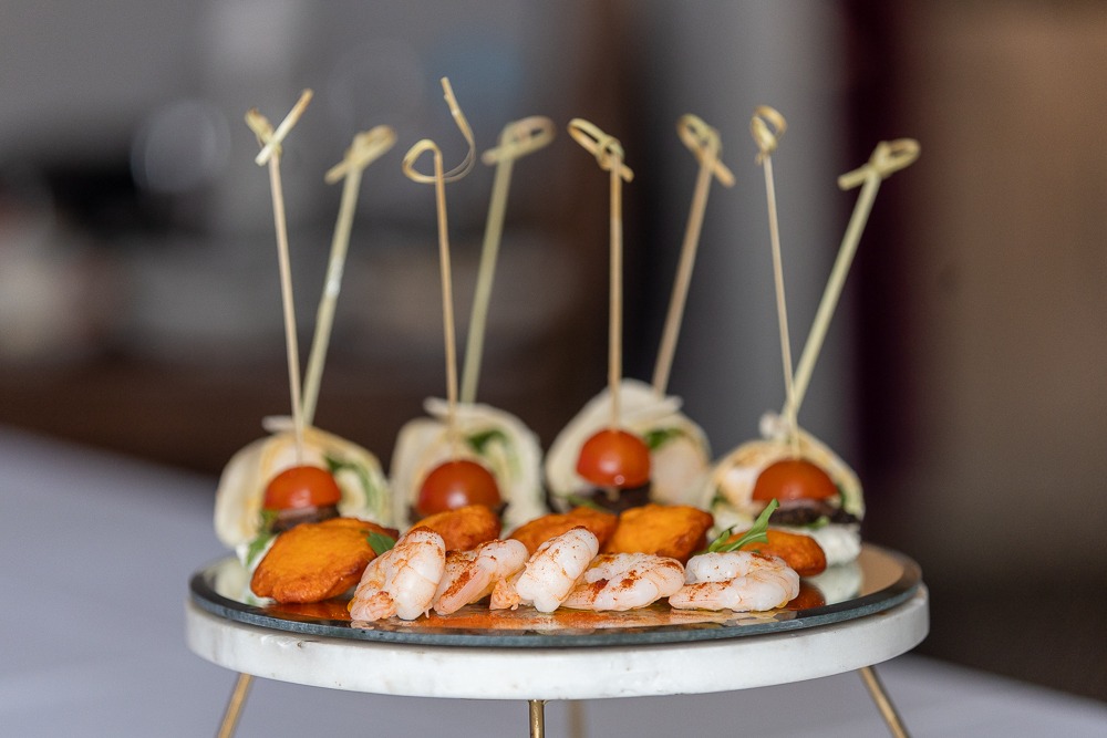 Elegant canapés with shrimp and cherry tomatoes on a tiered stand