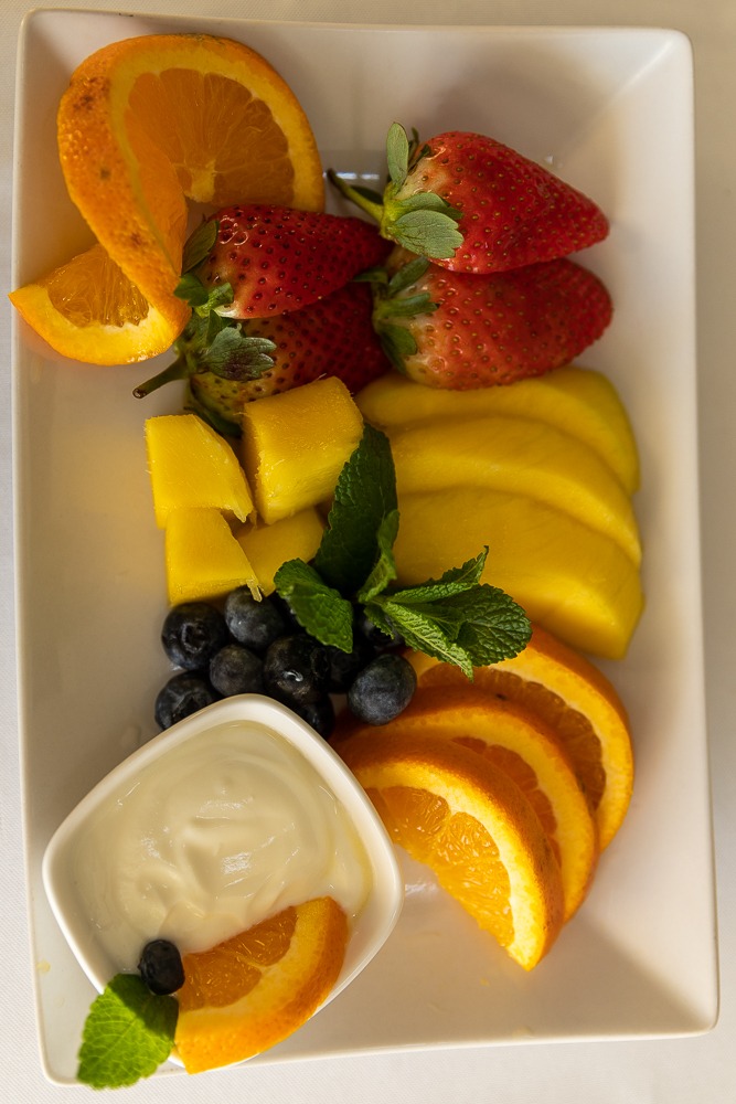 Overhead shot of fresh fruit platter with mint garnish