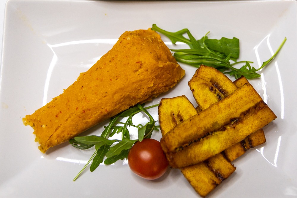 Moi moi bean pudding served with grilled plantain strips