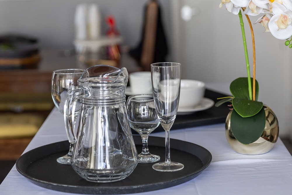 Elegant table setting with crystal glassware and white orchids